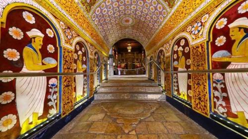 a hallway with paintings on the walls of a building at Kassapa Lions Rock in Sigiriya