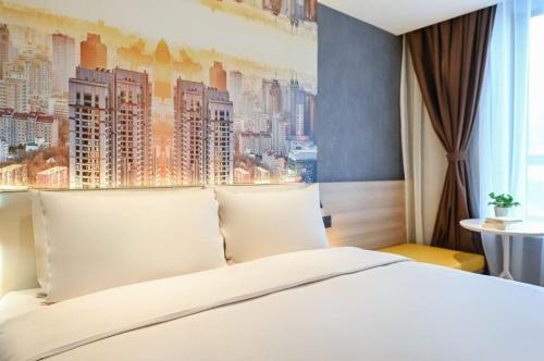 a bedroom with a white bed with a city painting on the wall at Atour Light Hotel Beijing West Station Maliandao in Beijing