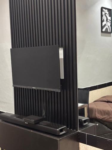 a flat screen tv on a dresser in a bedroom at Cityscape Apartment in Trofwi