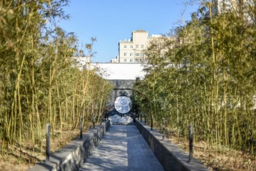 a walkway with trees and a building in the background at Atour Light Hotel Beijing West Station Maliandao in Beijing