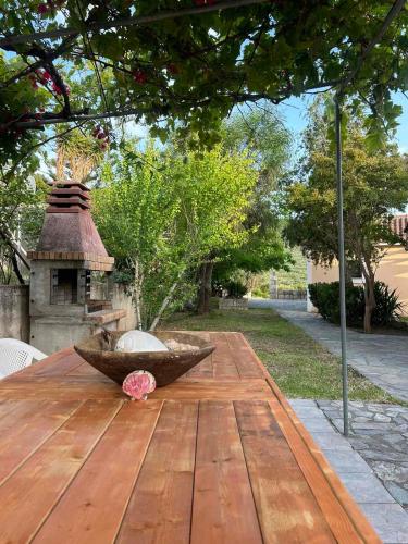 a wooden table with a bowl on top of it at Anabelis studios & apartments in Katelios