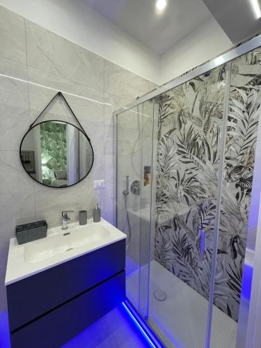a bathroom with a sink and a shower with a mirror at Casa Vacanza Venere in Barletta