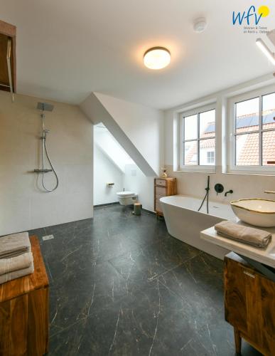 a bathroom with a large tub and a sink at Haus Casper Ferienwohnung 2 in Langeoog