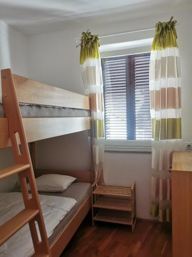 a bedroom with bunk beds and a window at Istrian old town apartment in Koper