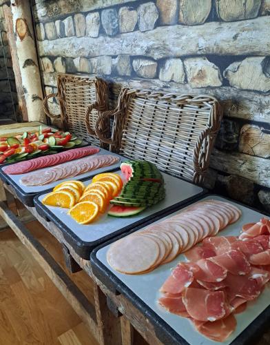 a table with different types of meat and vegetables at Kjølen Hotel Trysil in Trysil