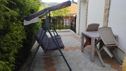 a umbrella on a patio with a table and chairs at SAN in Vrdnik