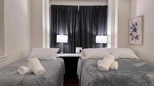 two beds in a hotel room with pillows on them at 9 Queen Beds, 18 Guests-Kleinburg Luxe Crown Town Residence in Vaughan