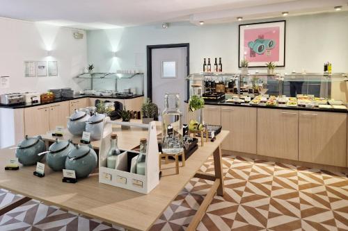 a kitchen with a table with food on it at Garner Hotel Oberhausen in Oberhausen