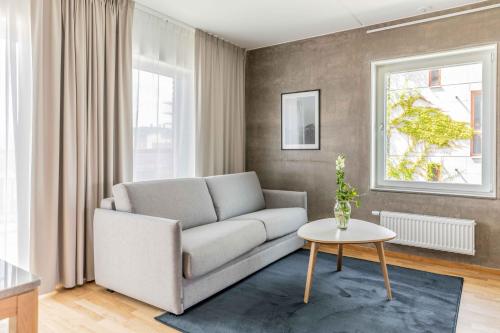 a living room with a couch and a table at The More Hotel Västra Hamnen in Malmö