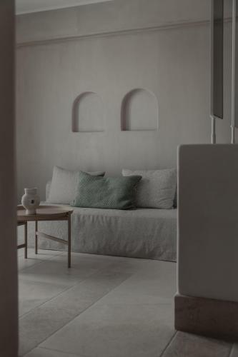 a living room with a couch and a table at Akria Seaside Suites in Naousa