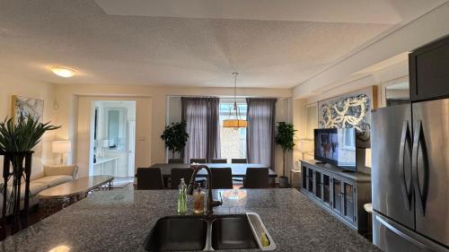 a kitchen and living room with a refrigerator and a living room at 9 Queen Beds, 18 Guests-Kleinburg Luxe Crown Town Residence in Vaughan