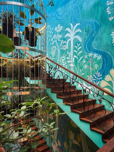 a staircase in a building with a mural at Kandy Dendrobium House in Kandy