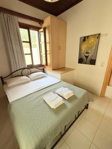 a bedroom with a bed with two towels on it at Lagom House in Panagia