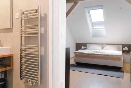 a bedroom with a bed and a window at Lilija apartments in Trzin