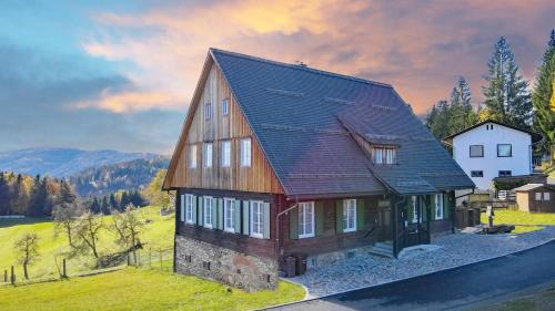 a house with a gambrel roof on a green field at Katharina Haus, Wiel in Wiel