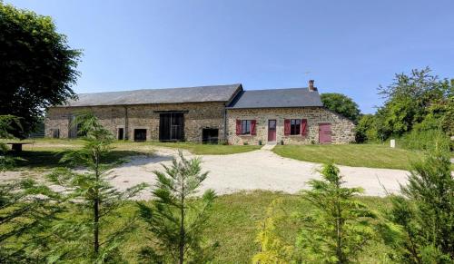 an old stone house with red shutters at La campagne in La Croisille-sur-Briance