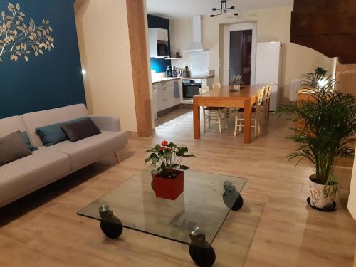 a living room with a couch and a table at La campagne in La Croisille-sur-Briance