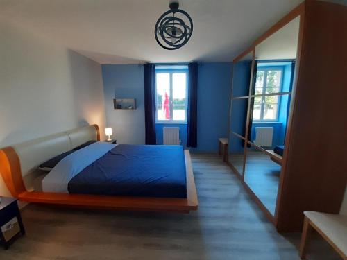 a bedroom with a large bed and a mirror at La campagne in La Croisille-sur-Briance