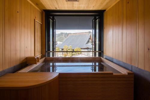 a sauna with a plunge pool and a window at Yatsusankan Over 6 years old in Hida