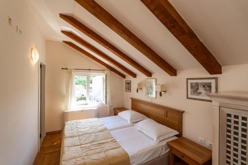 a bedroom with a bed and a window at Villa Alegria Cavtat in Cavtat