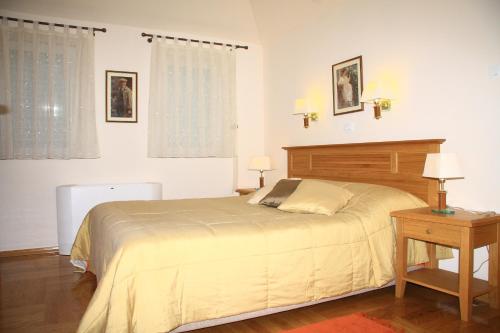 a bedroom with a large bed and a table at Villa Alegria Cavtat in Cavtat