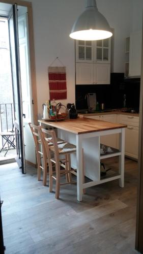 a kitchen with a white table with chairs and a light at I Vespri in Catania