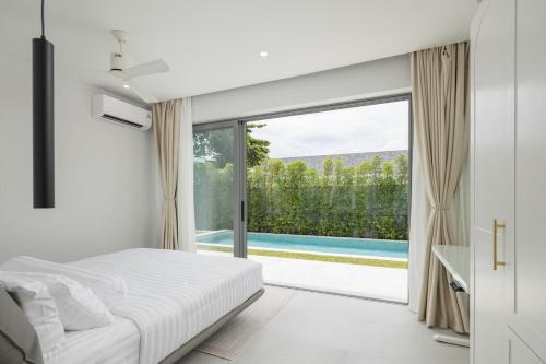 a bedroom with a bed and a large sliding glass door at Silk Villa - 3 Bedrooms - Pool - Central Area in Bophut