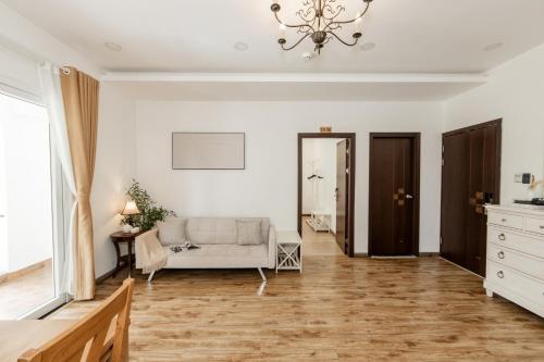 a living room with a couch and a chandelier at TTR Joy Apart' Hotel in Da Lat