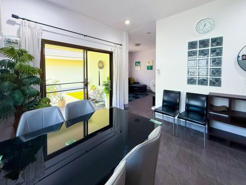 a living room with a dining table and chairs at Tropical 2 Bedroom Pool House In Central Location in Hua Hin