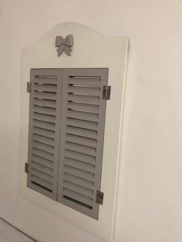a window with a bow on a white wall at La piccola casa di Tania in via Fieramosca in Terlizzi