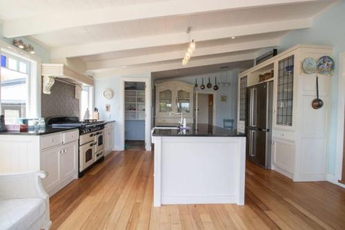 a kitchen with white cabinets and a white counter top at The Homestead - a rural family retreat in Sentry Hill