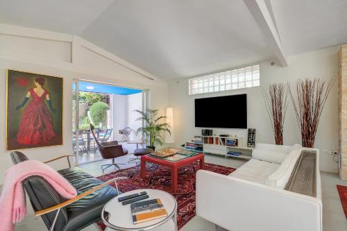 un salon avec un canapé et une télévision dans l'établissement Antibes Loft Retreat - Happy Rentals, à Juan-les-Pins