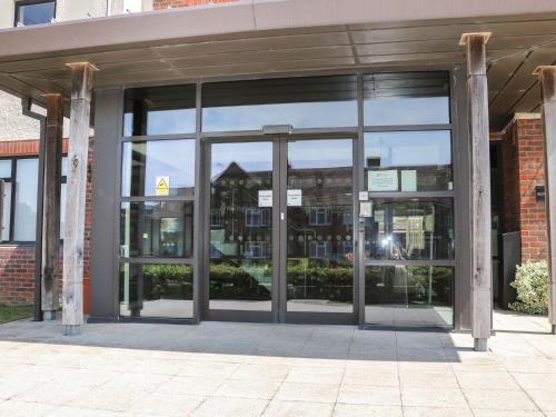 an entrance to a building with large glass doors at Pebble Path at Marine Court in Littlehampton