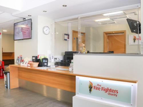 a fire fighters charity counter with a mirror at Pebble Path at Marine Court in Littlehampton