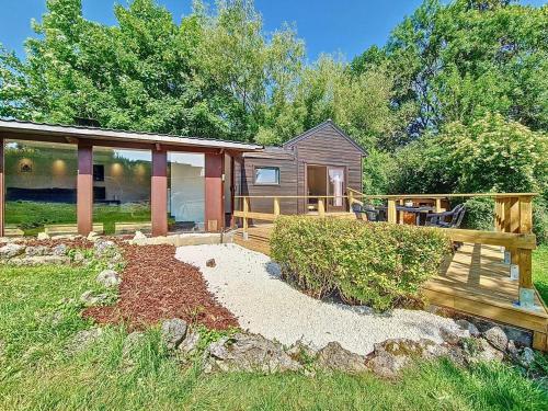 a home with a deck and a house at Le Chalet NaturZen in Hastière-par-delà