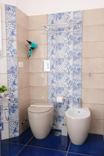 a bathroom with a toilet and a bidet at Pharus Miseni Suites and rooms in Bacoli