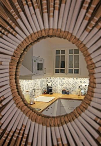 a kitchen with a round mirror in the foreground at Azure Haven in Hydra