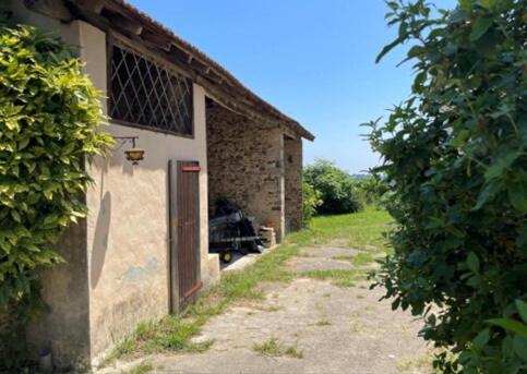 a stone building with a door on the side of it at Gite Des Cimes in Baigts-de-Béarn