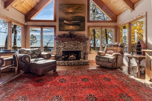 a living room filled with furniture and a fireplace at Canoe Believe It - Enjoy mountain views cook out on the Weber grill relax in Jasper