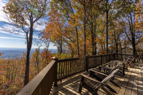 a group of benches on a wooden deck with trees at Canoe Believe It - Enjoy mountain views cook out on the Weber grill relax in Jasper