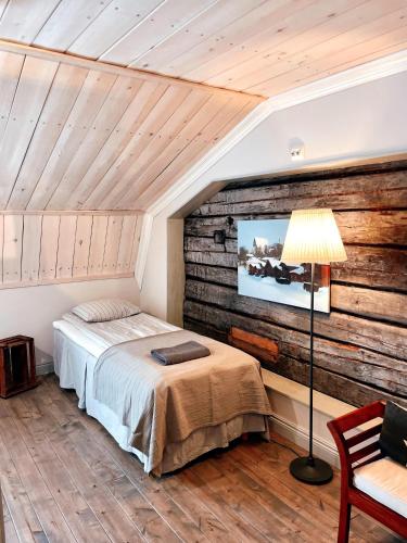 a bedroom with a bed and a tv on a wall at Old Town B&B Ida-Maria in Porvoo