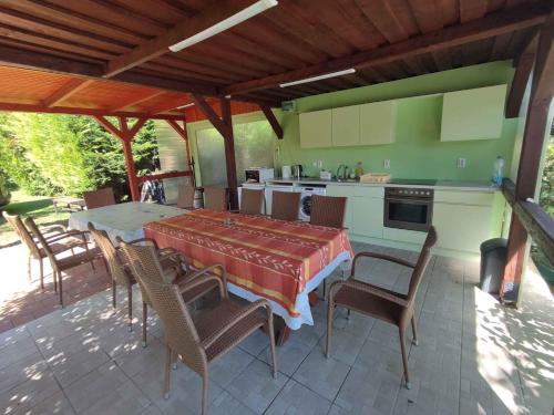 a patio with a table and chairs and a kitchen at Apartments in Balatonföldvar 45318 in Balatonföldvár