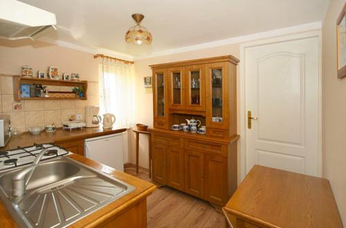 a kitchen with a sink and a counter top at Pensjonat Elżbieta in Łeba