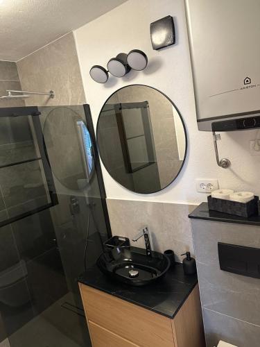 a bathroom with a sink and a mirror at Apartments Baričević in Bol