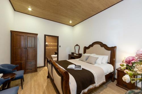 a bedroom with a bed and a desk and a chair at TTR Joy Apart' Hotel in Da Lat