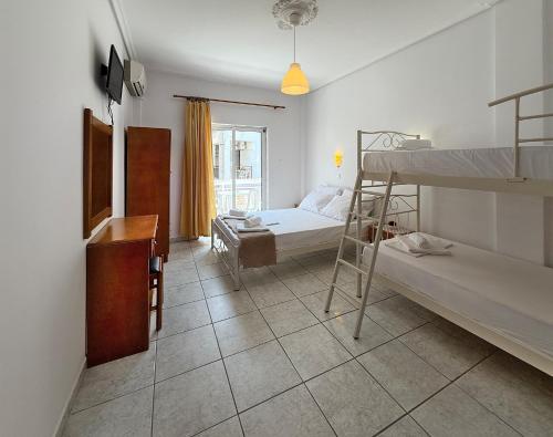 a bedroom with two bunk beds and a desk at MELI Studios by SDR in Paralia Katerinis