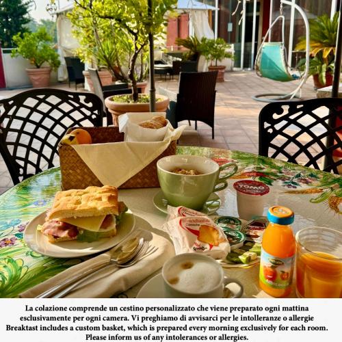 uma mesa com uma sanduíche e uma chávena de café em Miglioranzi Rooms em Verona