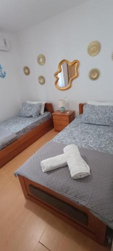 a bedroom with two beds and a mirror on the wall at Villa Alba in Koinyra