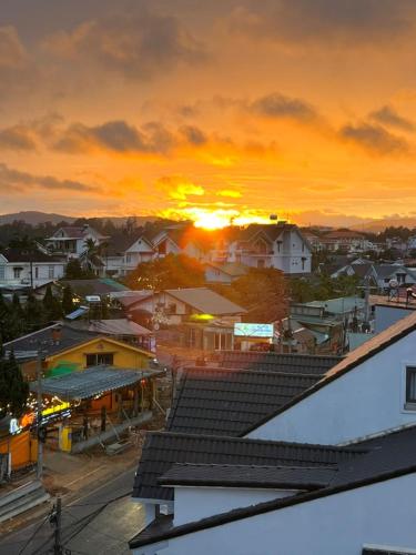 a sunset over a small town with houses at ORCHID Hotel in Da Lat