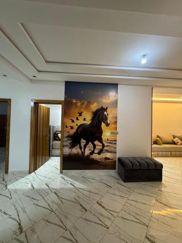 a painting of a horse running in a room at Petite villa benkrara فيلا صغيرة بن كرارة in Iterkine